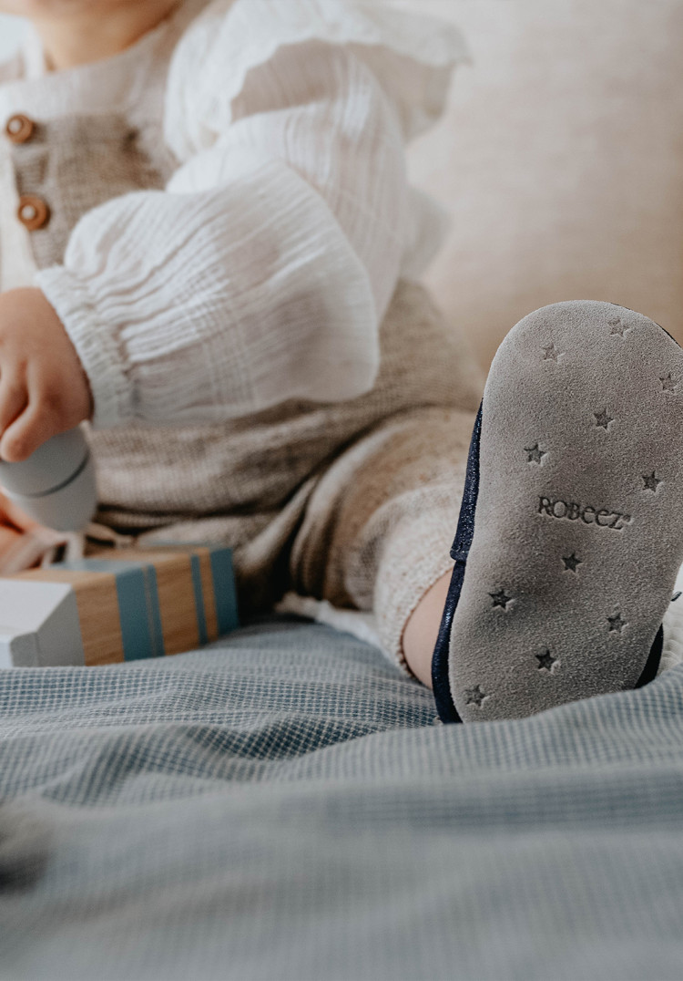 How should you clean your soft leather baby slippers?